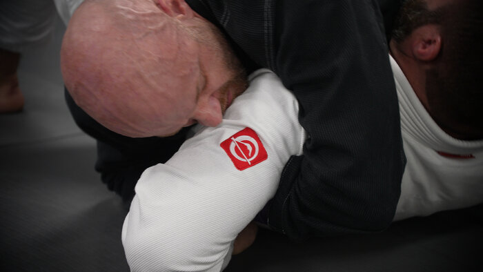 Chad E Foster practicing Brazilian Jiu-Jitsu, showing physical fitness and determination