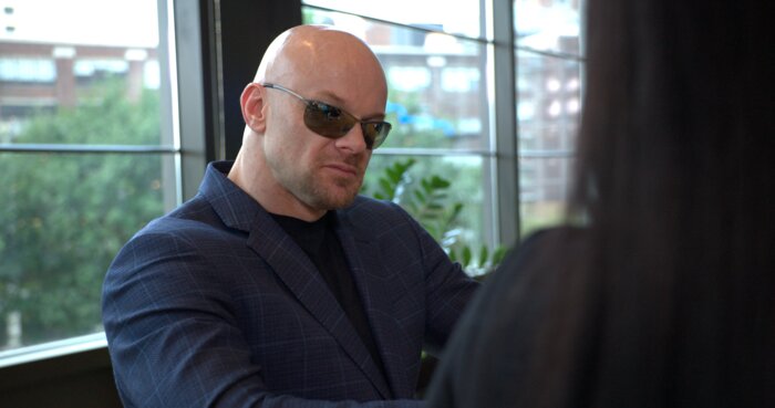 Chad E Foster in business meeting setting with corporate executives