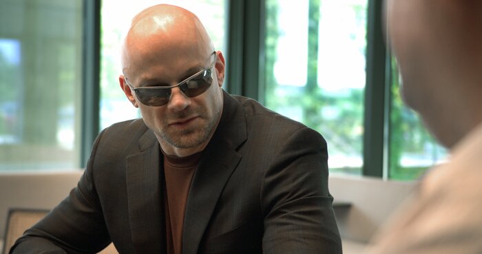 Close-up of Chad E Foster in business meeting providing strategic insights